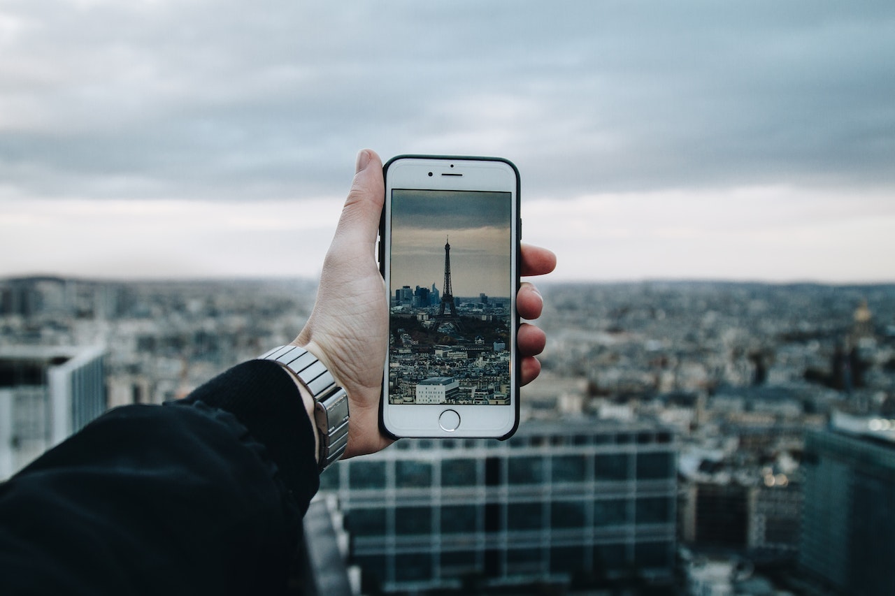 Traveler taking photo of Eiffel Tower on phone
