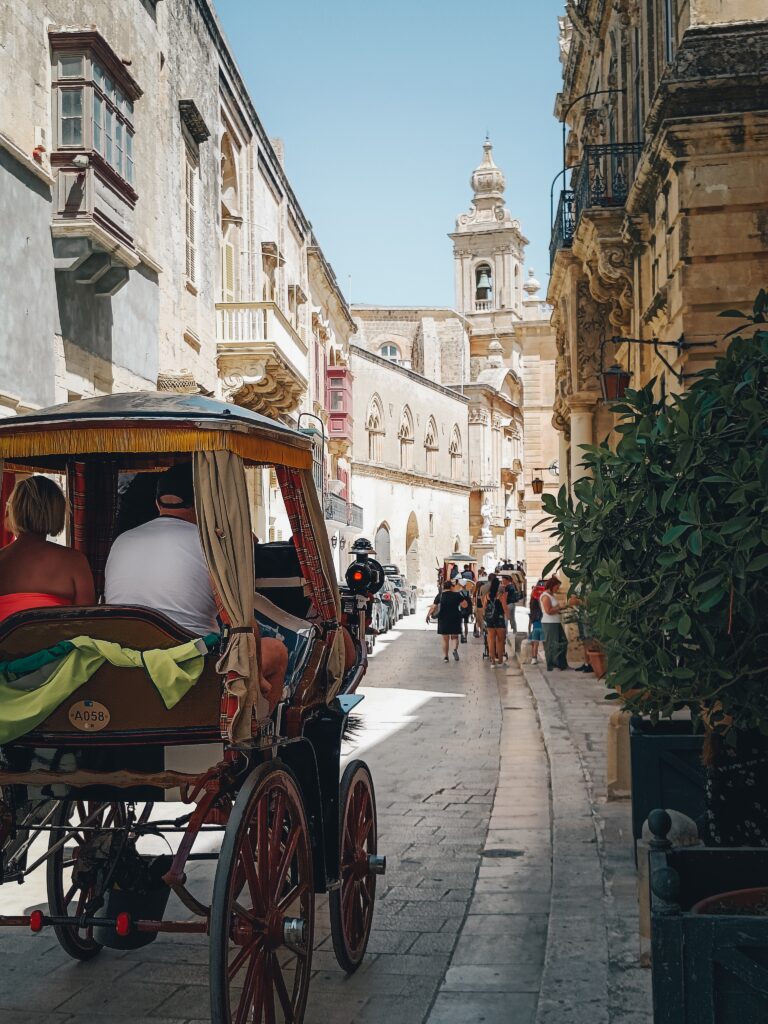 Malta old fashioned carriage on cobblestone street. 